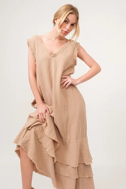 Light beige tiered dress with fringe details from Trendsi's And The Why Washed Fringe collection, featuring a relaxed fit and sleeveless design.