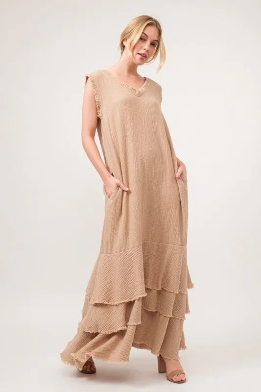 Sand-colored tiered dress with washed finish and fringe details by Trendsi, featuring a flowing, layered design.