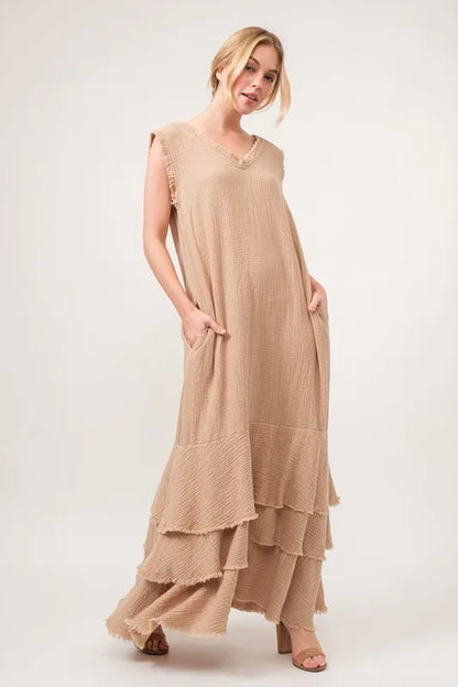 Sand-colored tiered dress with washed finish and fringe details by Trendsi, featuring a flowing, layered design.