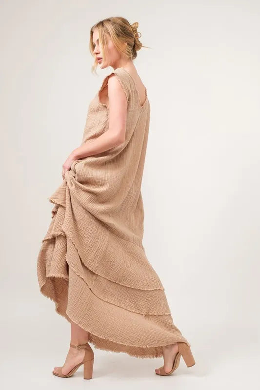 Sand-colored And The Why washed fringe detail tiered dress by Trendsi, featuring layered fabric and fringe accents, casual summer style