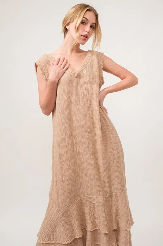 Sand-colored And The Why washed fringe detail tiered dress by Trendsi, featuring layered fabric and fringe accents.