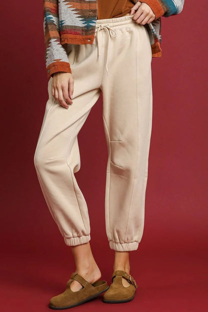 Sand-colored Umgee fleece jogger pants with drawstring waist and elastic cuffs, casual and comfortable for everyday wear.