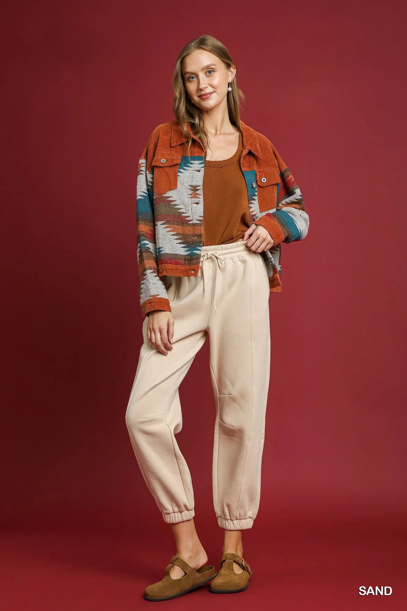 Light beige Umgee fleece jogger pants with drawstring waist and relaxed fit, shown in XS size.