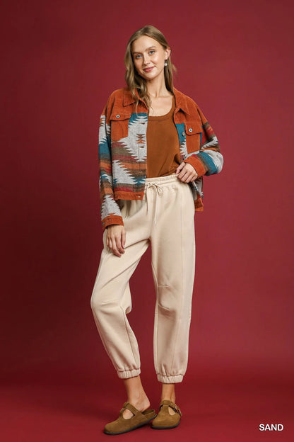 Light beige Umgee fleece jogger pants with drawstring waist and relaxed fit, shown in XS size.