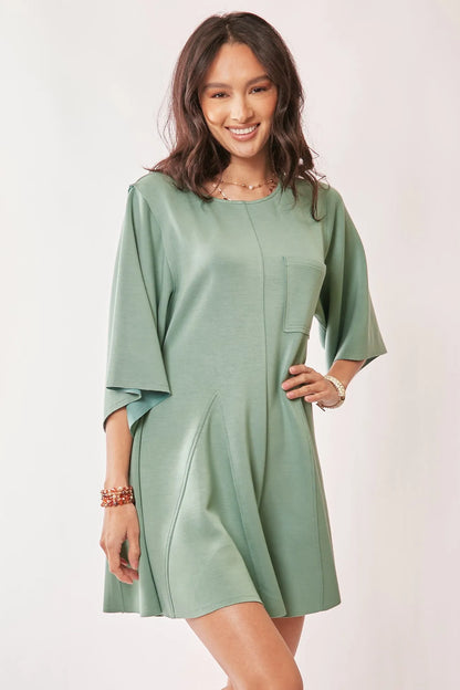 Seafoam green Davi & Dani solid skort romper with draped sleeves and ties at the back, stylish and comfortable for warm weather.