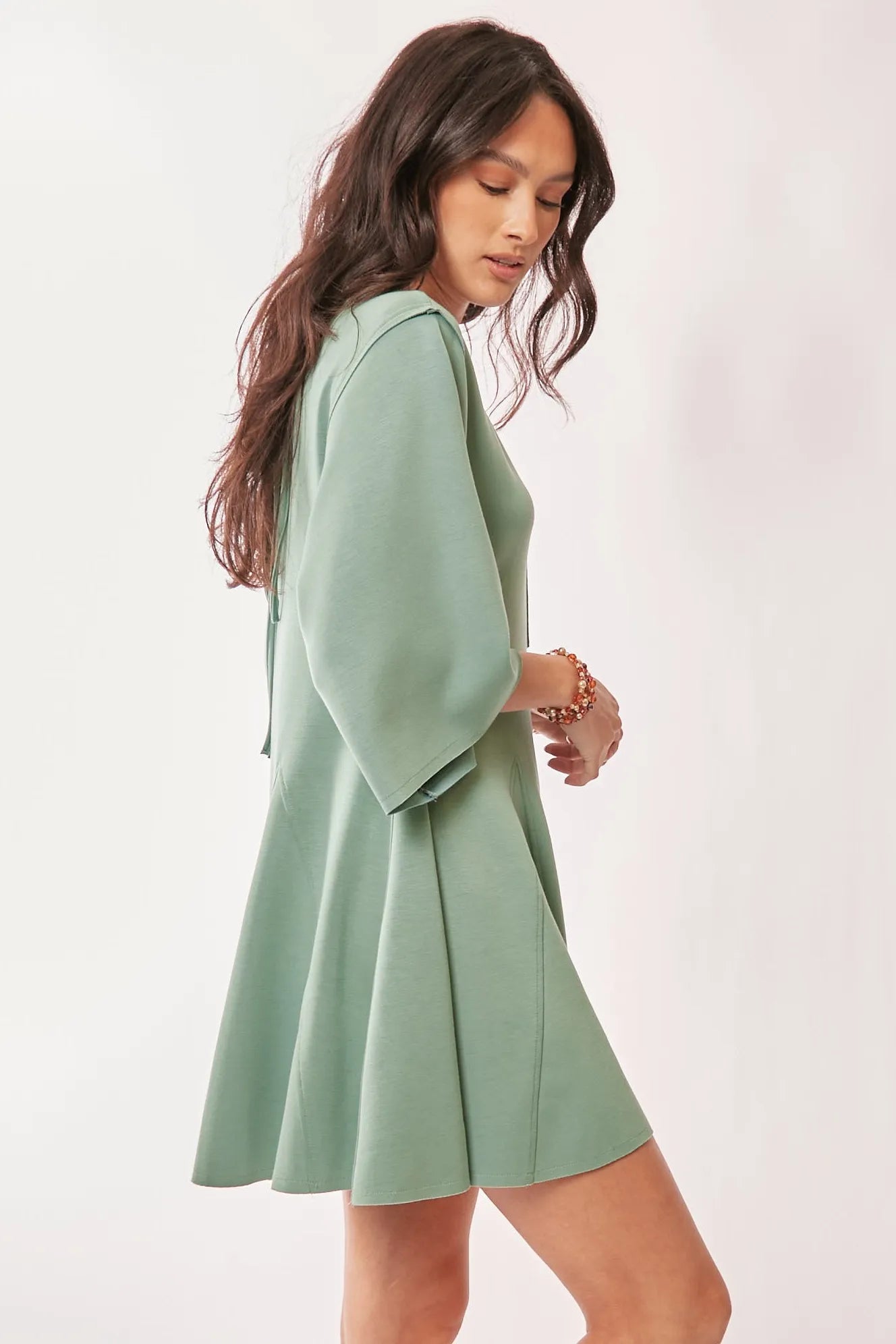 Seafoam green Davi & Dani solid skort romper with draped sleeves and ties at the back, stylish and comfortable for casual wear.