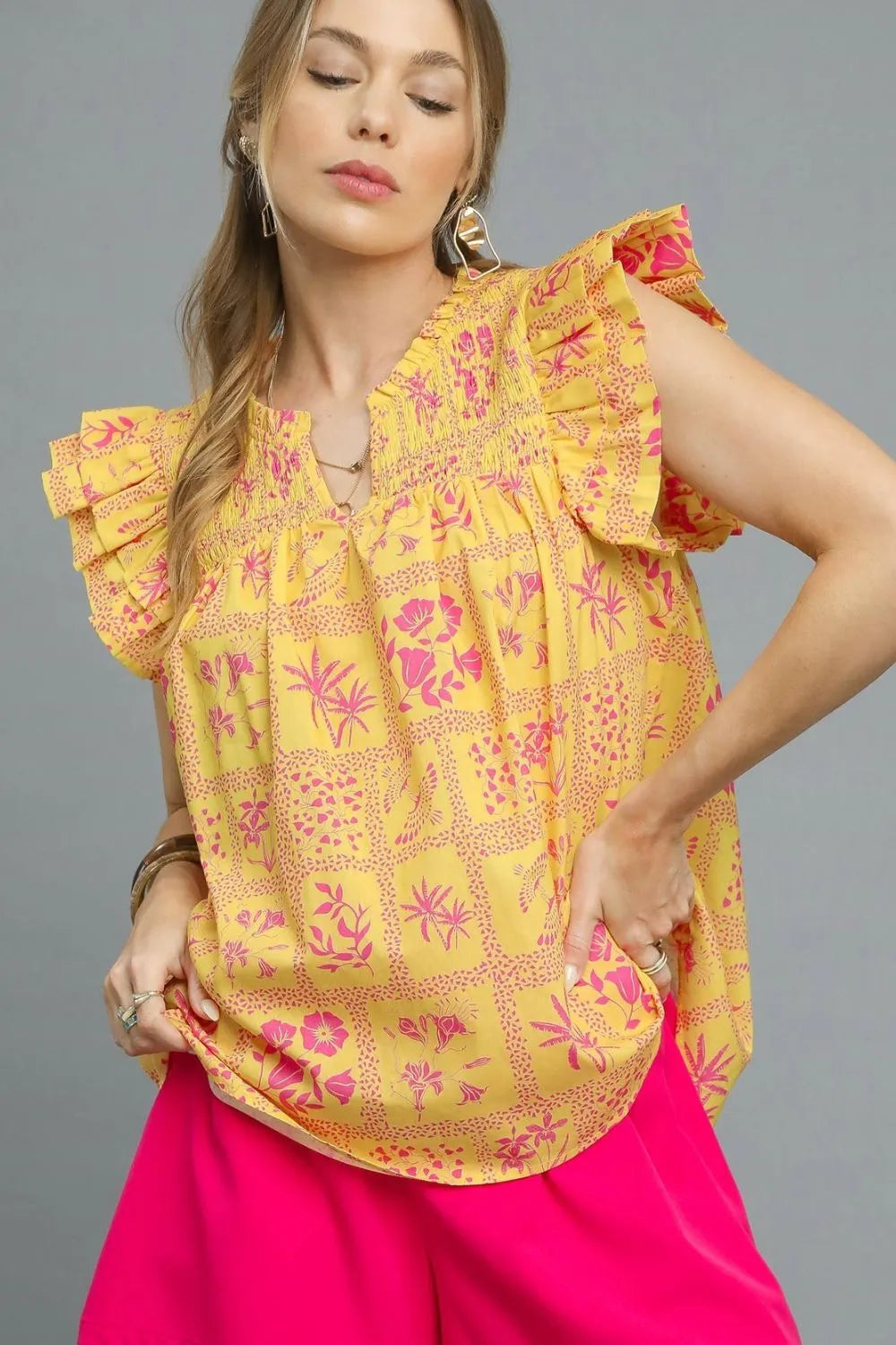 Umgee printed ruffle cap sleeve blouse in sherbet color, featuring a stylish design and feminine ruffle details.