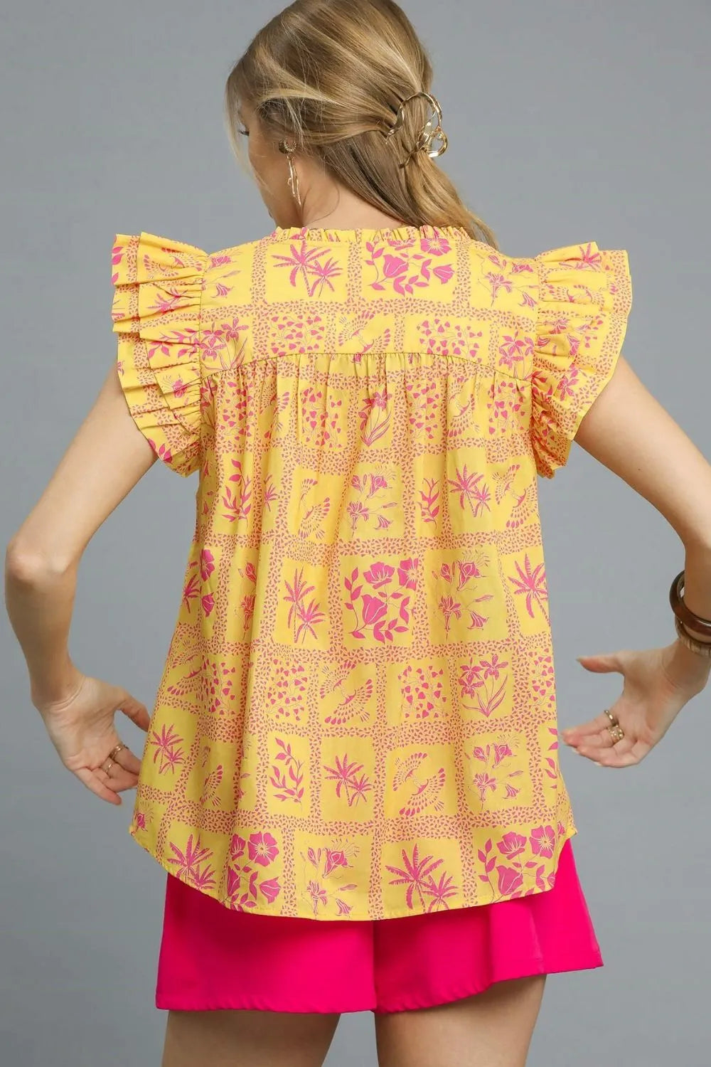 Umgee printed ruffle cap sleeve blouse in sherbet color, featuring floral design and feminine ruffle details.