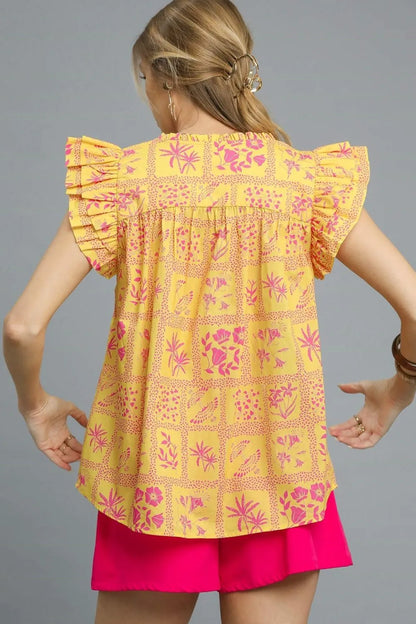 Umgee printed ruffle cap sleeve blouse in sherbet color, featuring floral design and feminine ruffle details.