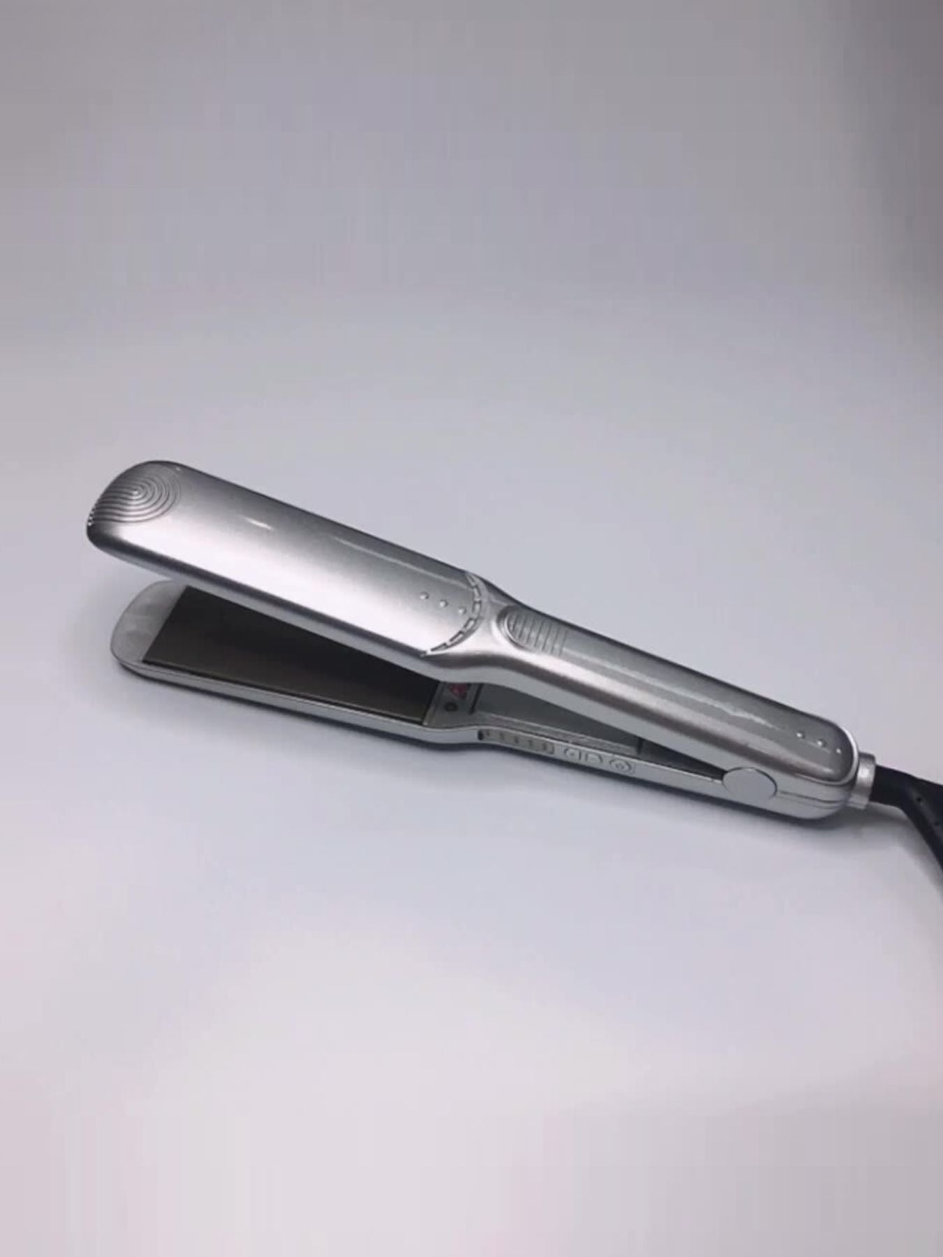 Silver Trendsi adjustable temperature hair straightener with North American plug, featuring sleek design and temperature control.