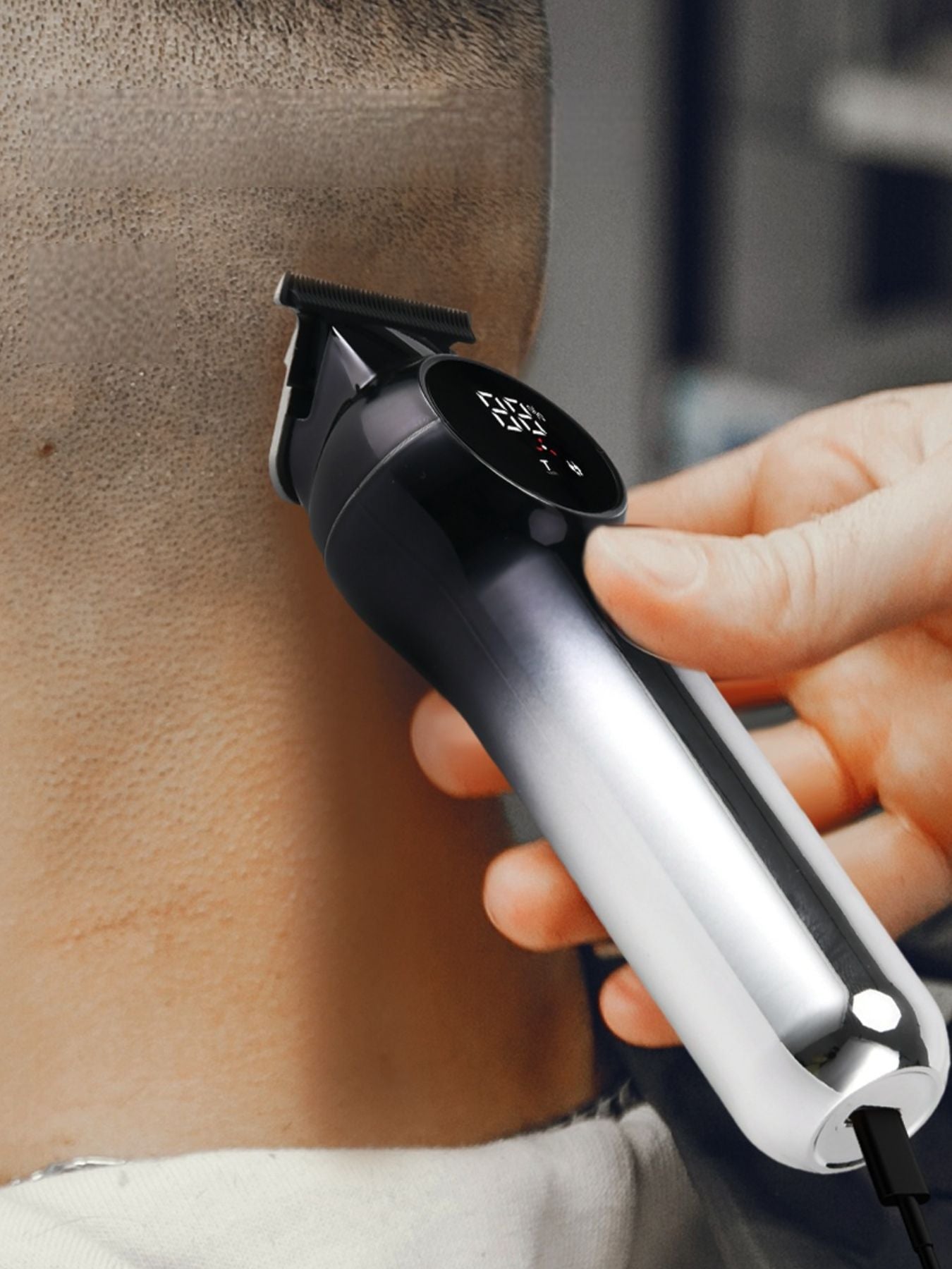Silver rechargeable hair clipper from Trendsi with adjustable blades, ideal for styling and grooming.
