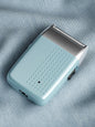 Sky blue portable electric shaver by Trendsi with a compact design and easy grip for grooming on the go.
