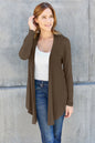 Sky-blue Trendsi Basic Bae open front long sleeve cardigan displayed on a hanger, showcasing its relaxed fit and soft fabric.