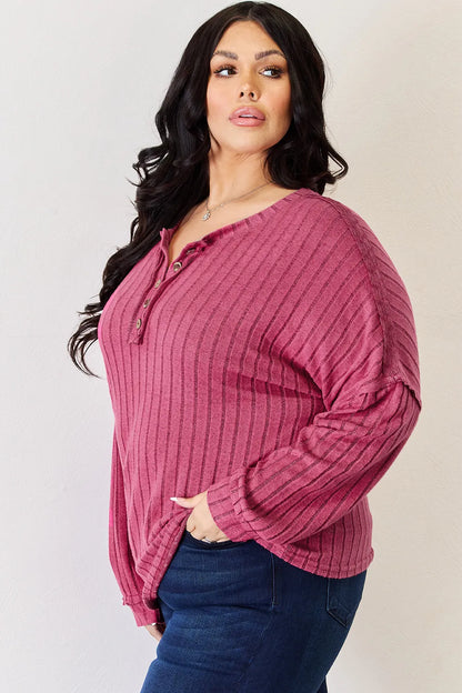 Sky blue Basic Bae ribbed half-button long sleeve high-low T-shirt from Trendsi, showcasing its casual fit and textured fabric.