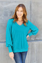 Sky-blue Basic Bae V-Neck Lantern Sleeve Top by Trendsi, full-size, lightweight fabric, with a relaxed fit and stylish lantern sleeves.