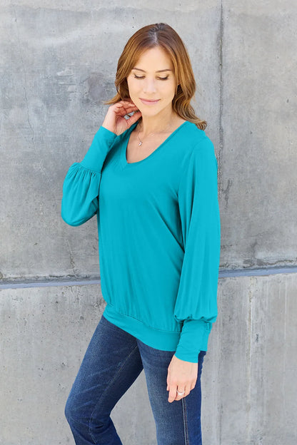 Sky blue Trendsi Basic Bae V-neck lantern sleeve top, full size, casual women's blouse with flowing lantern sleeves.