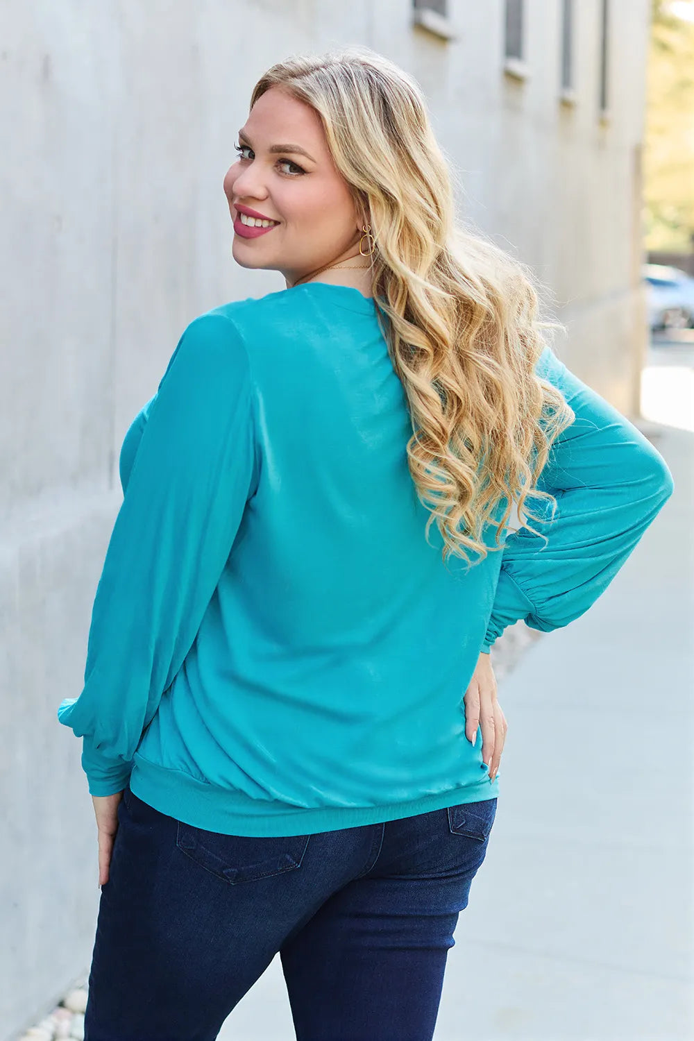 Sky-blue Basic Bae full-size V-neck lantern sleeve top by Trendsi, showing the relaxed fit and stylish design.