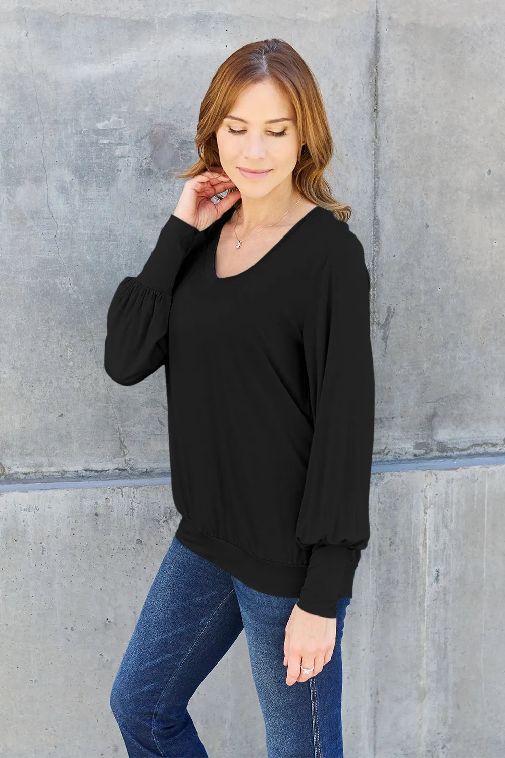 Sky blue Trendsi Basic Bae full-size V-neck lantern sleeve top displayed on a mannequin with a relaxed fit and stylish design.