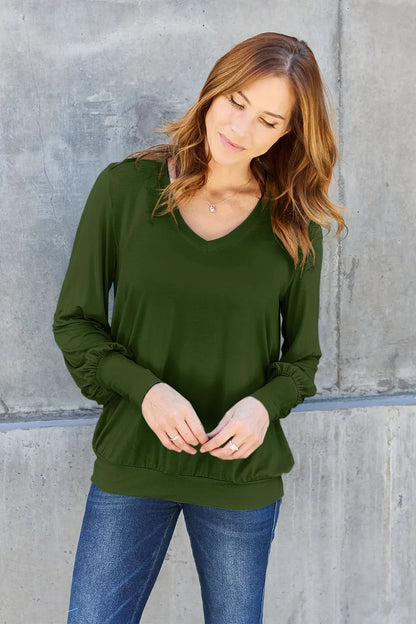 Sky blue Basic Bae full-size V-neck lantern sleeve top from Trendsi, featuring a relaxed fit and stylish design.