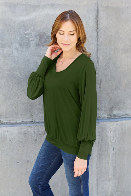 Sky-blue Basic Bae full-size V-neck lantern sleeve top by Trendsi, featuring a relaxed fit and stylish long lantern sleeves.