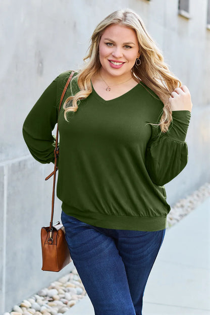 Sky blue Basic Bae V-neck lantern sleeve top by Trendsi, featuring a relaxed fit and stylish long lantern sleeves.