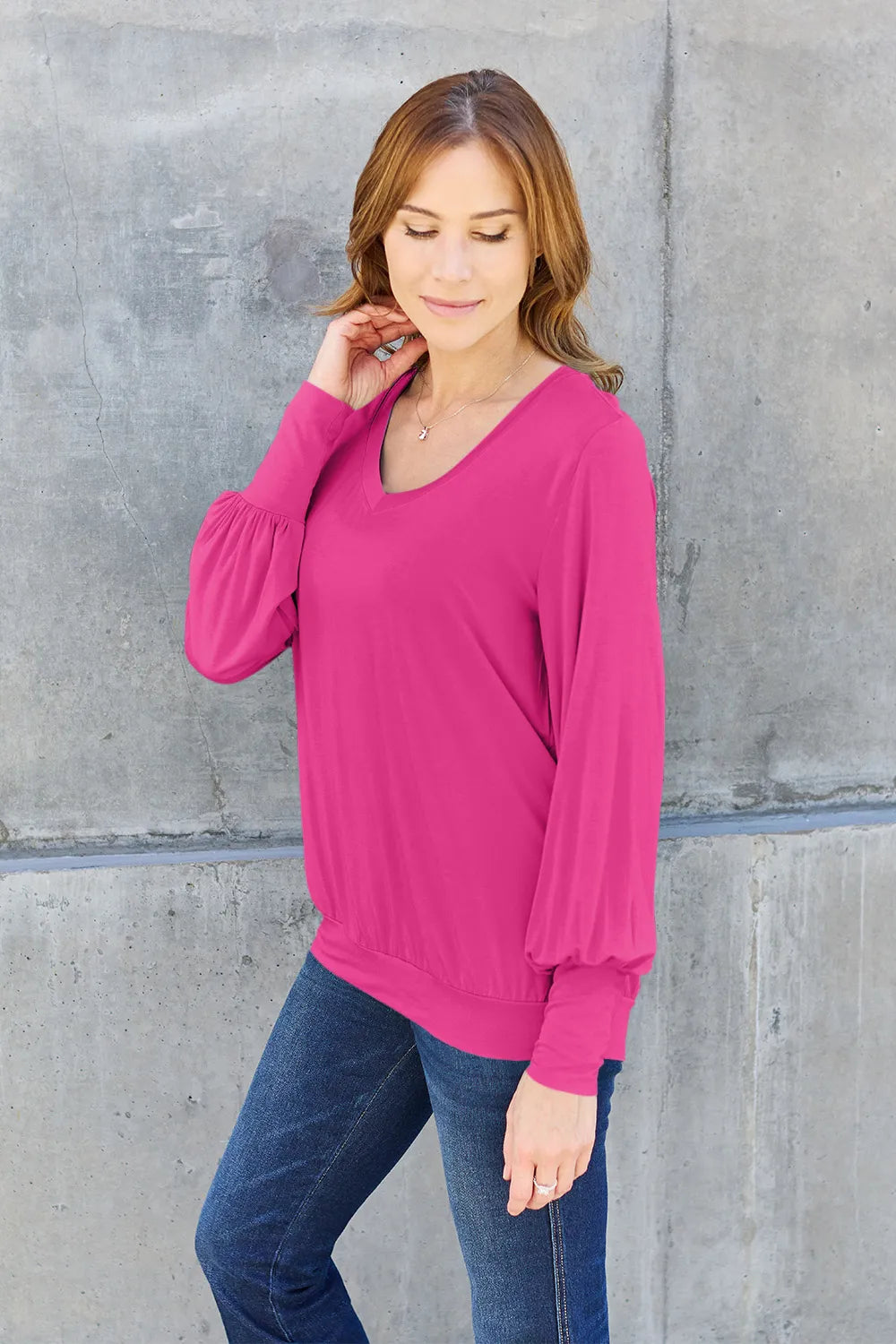 Sky blue Basic Bae V-neck lantern sleeve top by Trendsi, shown on a model, featuring a relaxed fit and stylish design.