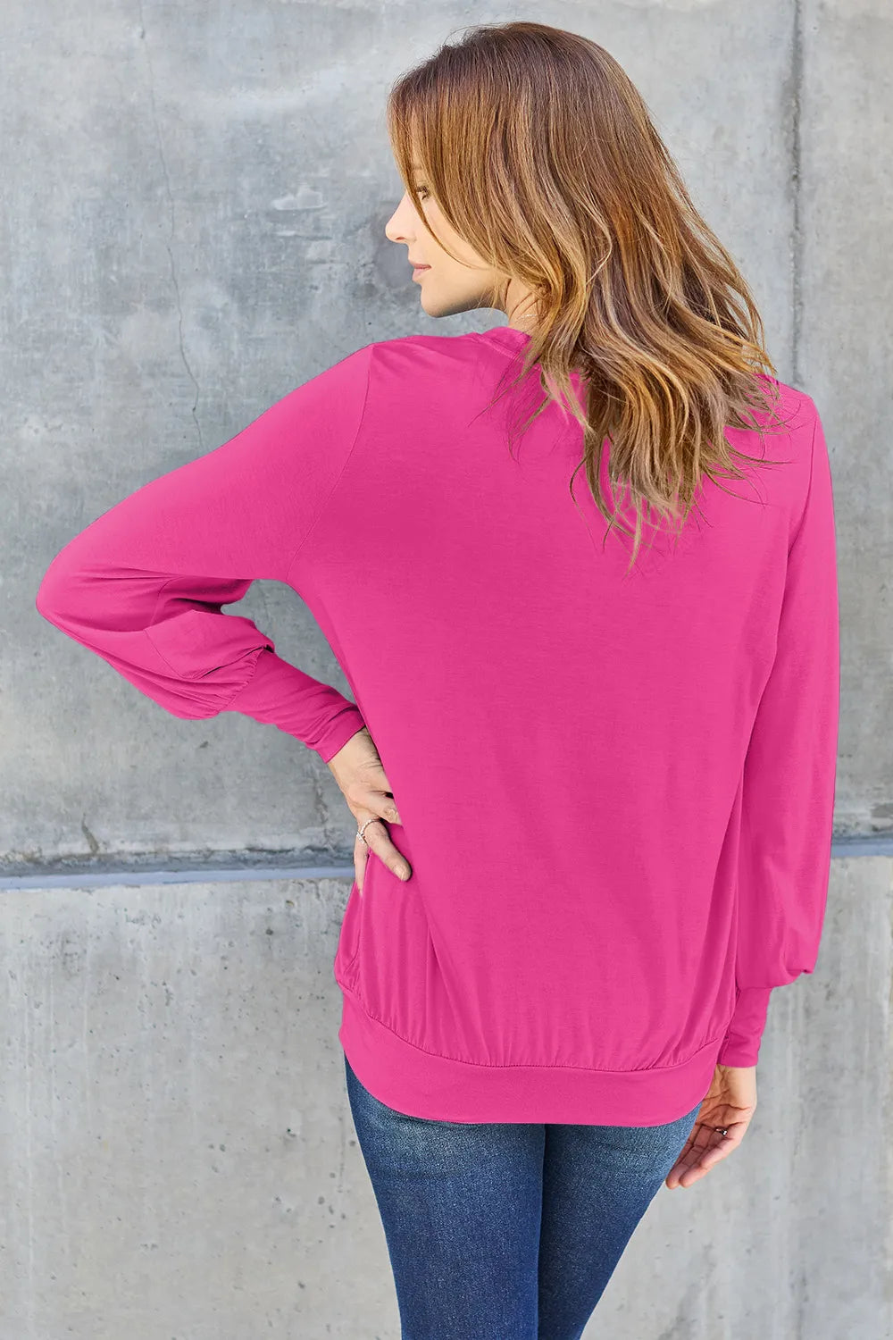 Sky blue Basic Bae full-size V-neck lantern sleeve top by Trendsi, shown on a model with a relaxed fit and stylish design.