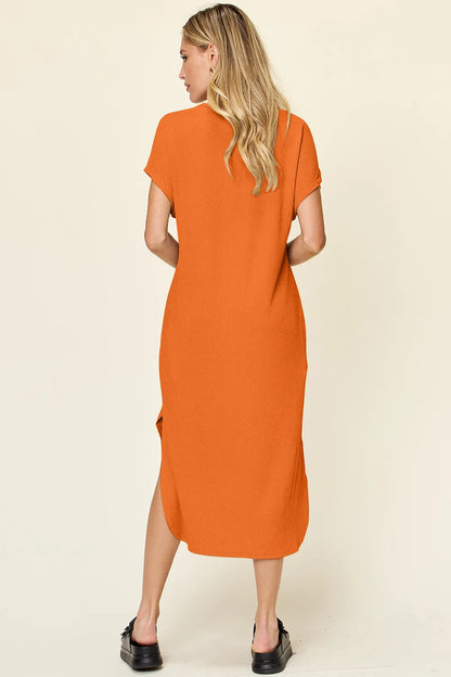 Sky-blue Trendsi Double Take full-size round neck short sleeve slit dress displayed on a hanger.