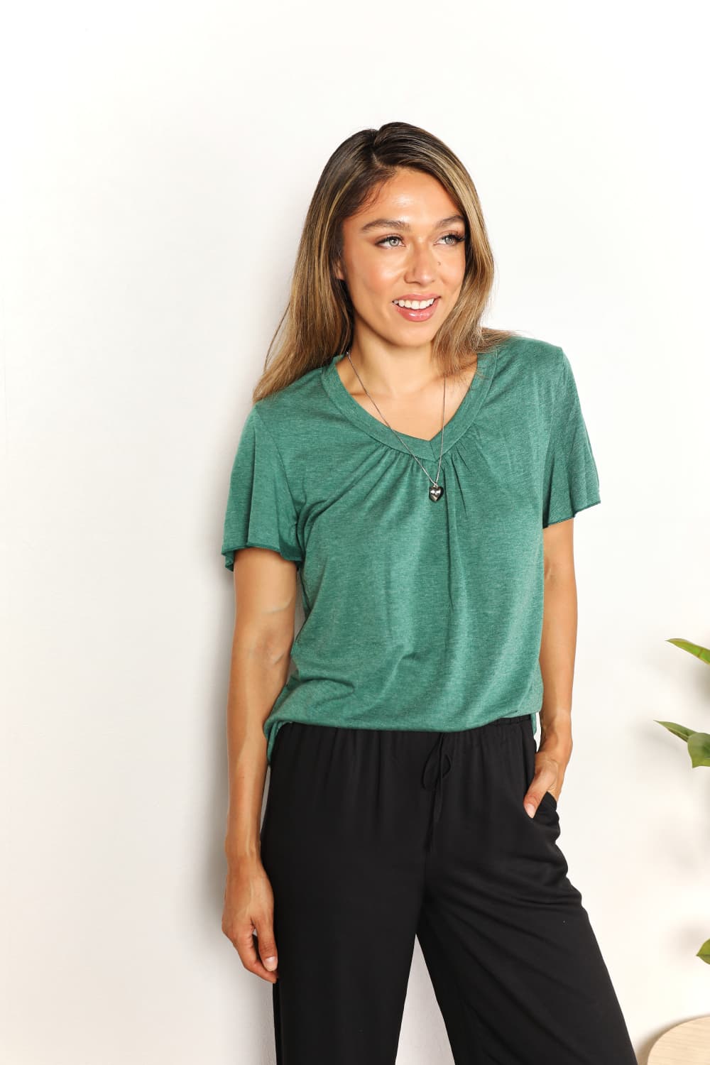 Sky blue Double Take Ruched V-Neck Short Sleeve T-Shirt by Trendsi, featuring a fitted design with ruched details and a V-neckline.