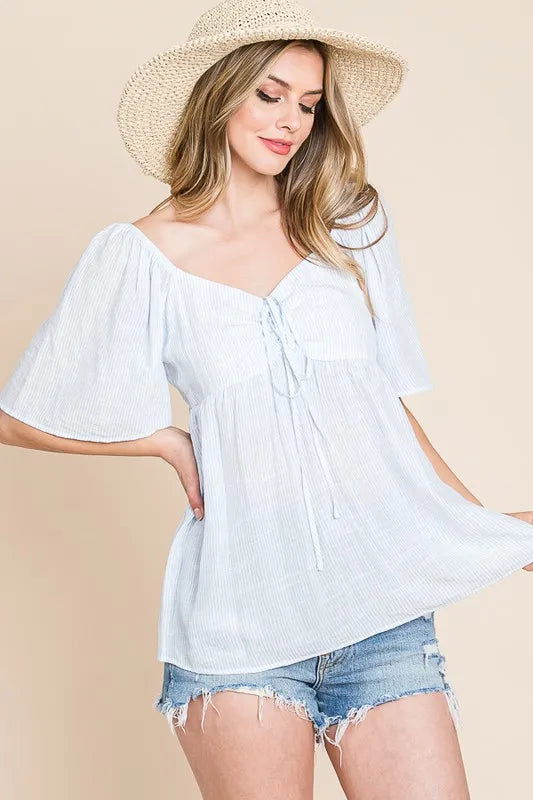 Sky-blue Lime 'N' Chili thin striped babydoll top with tie front from Trendsi, featuring a relaxed fit and stylish design.