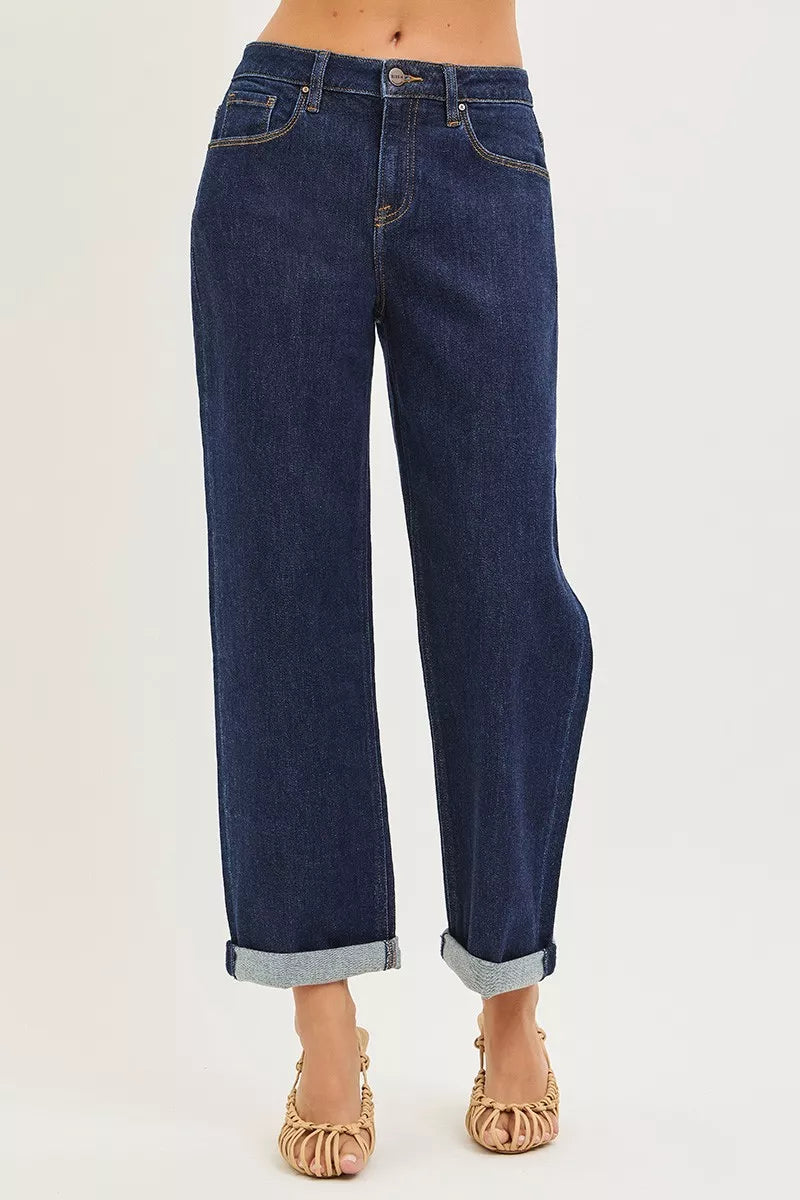 Risen slouchy cropped boyfriend jeans with cuffed hem, dark wash, relaxed fit, and distressed details, casual denim style.