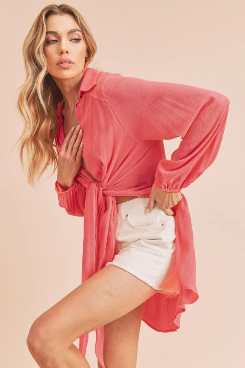 Aemi + Co tied collared neck long sleeve top in strawberry red, featuring a stylish collar and fitted long sleeves.