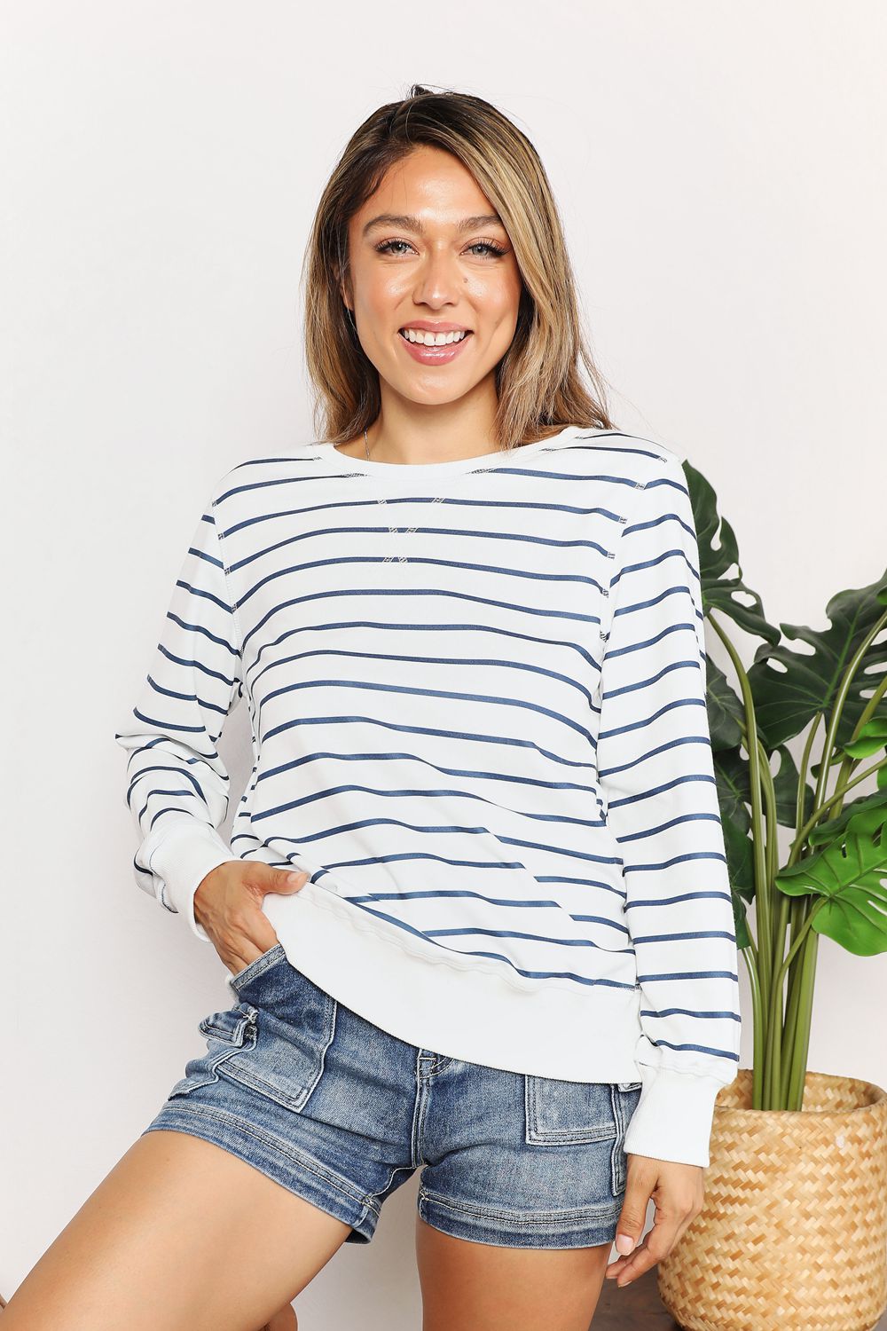 Trendsi Double Take striped long sleeve round neck top featuring bold horizontal navy and white stripes.