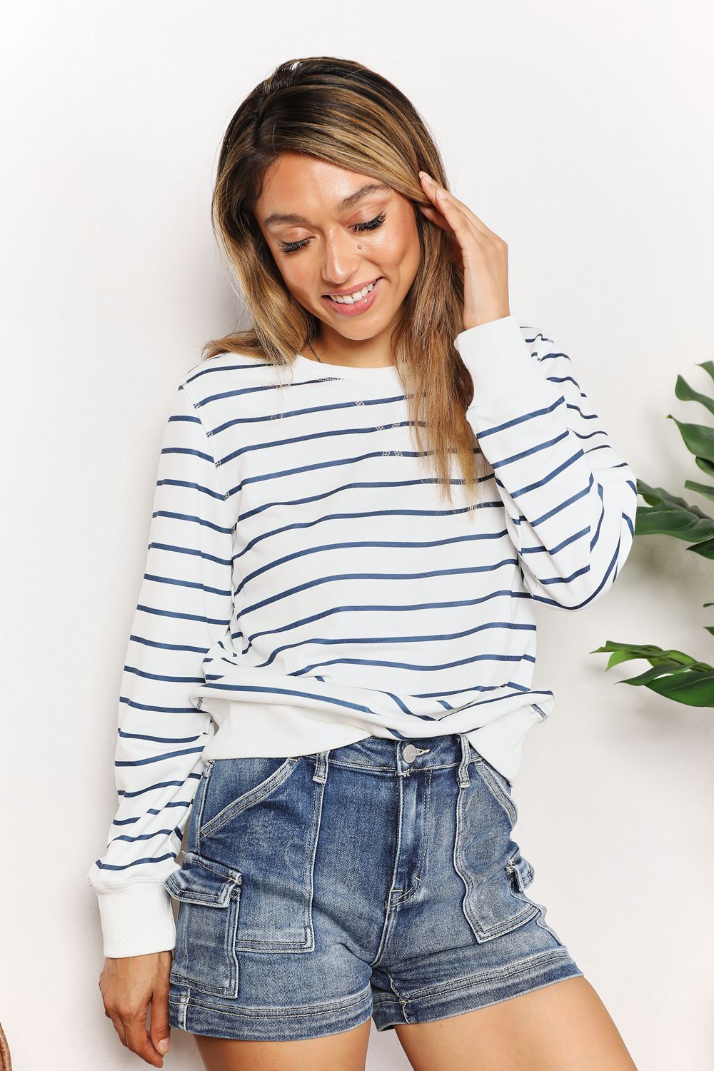 Long sleeve round neck top with blue and white stripes by Trendsi, featuring a relaxed fit and classic design.