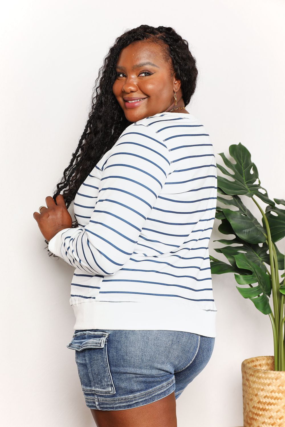 Striped long sleeve round neck top from Trendsi's Double Take collection, featuring a comfortable fit and classic design.