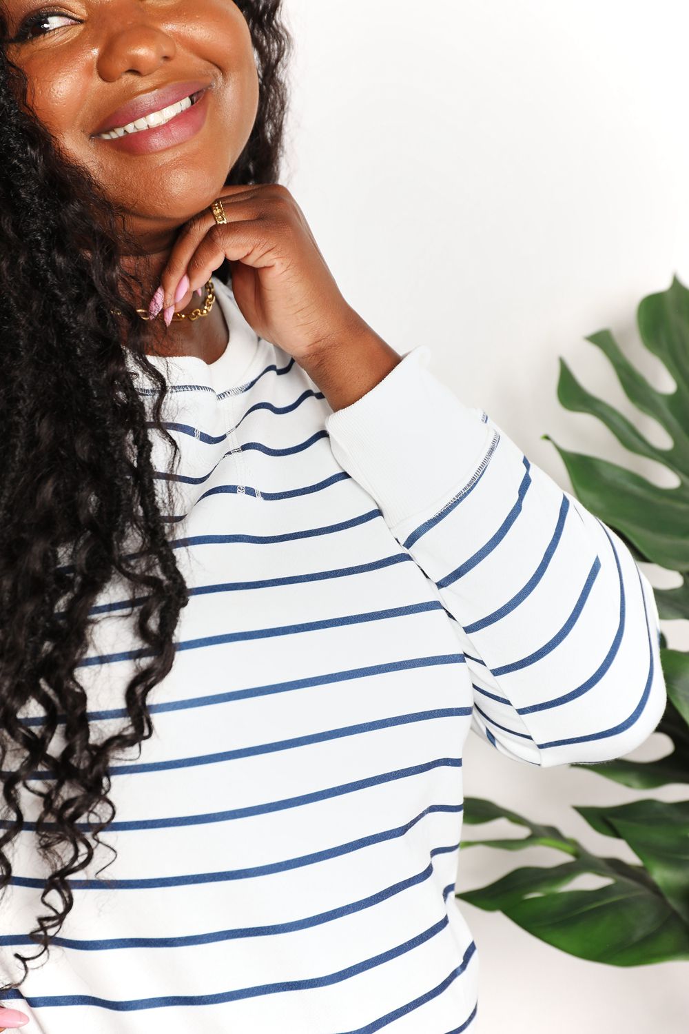 Striped long sleeve round neck top by Trendsi, featuring a comfortable fit and classic design in a stylish pattern.
