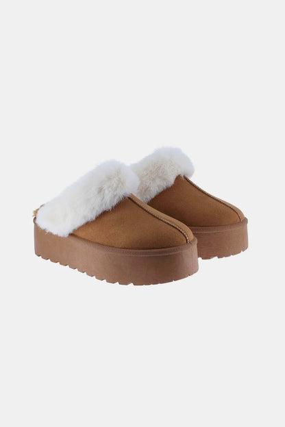 Tan Weeboo snow slippers with thick soles and fur trim, designed for warmth and comfort in winter weather.
