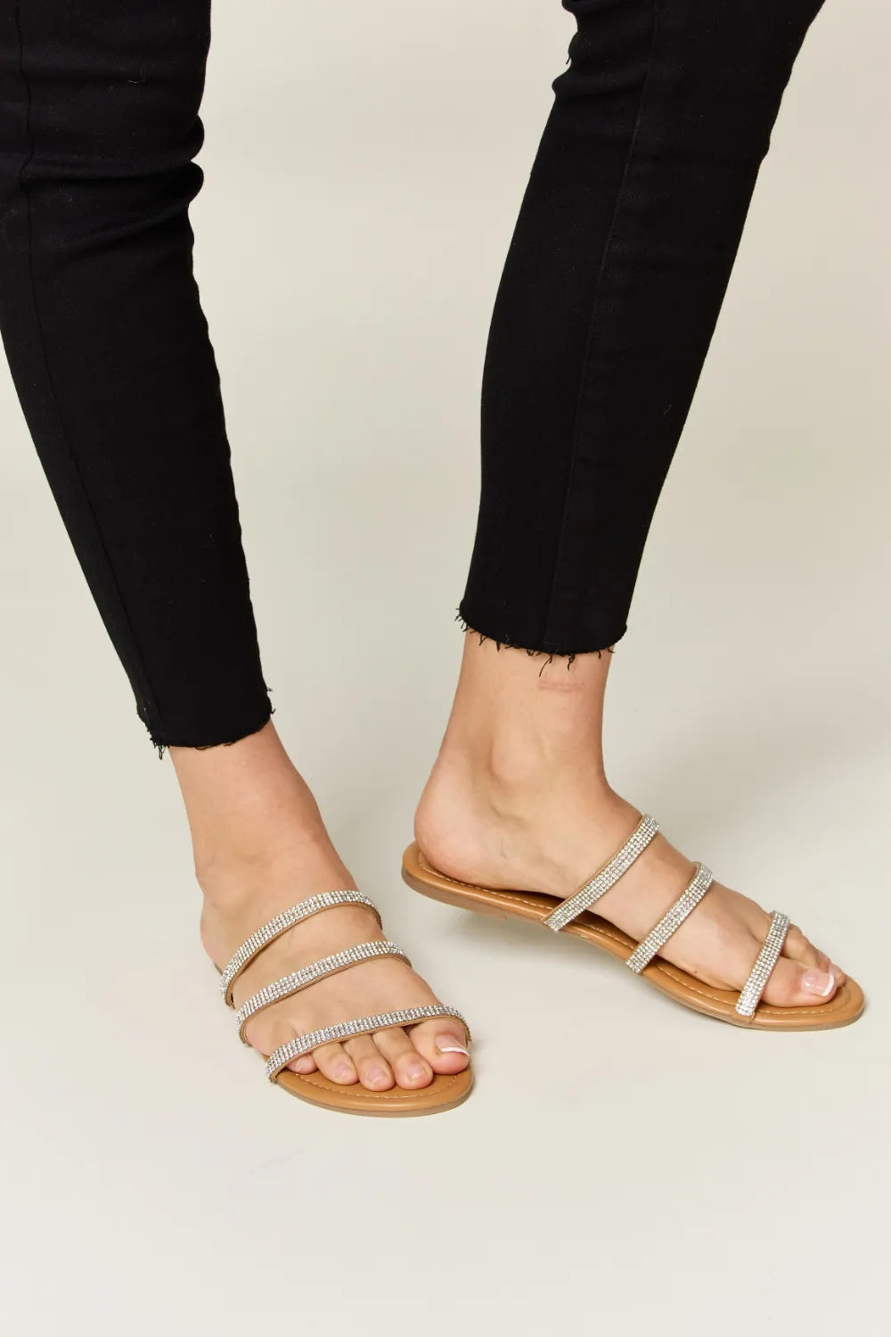 Tan WILD DIVA Rhinestone Three-Strap Flat Sandals by Trendsi, featuring sparkling rhinestones and comfortable flat design.