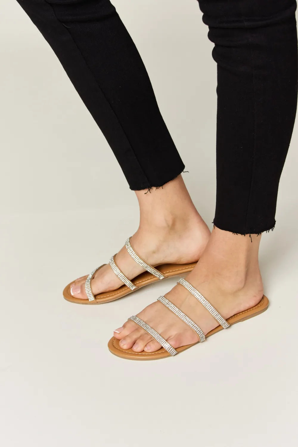 Tan Wild Diva rhinestone three-strap flat sandals with decorative rhinestones and comfortable flat sole.