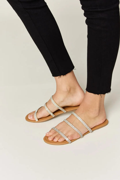 Tan Wild Diva rhinestone three-strap flat sandals with decorative rhinestones and comfortable flat sole.
