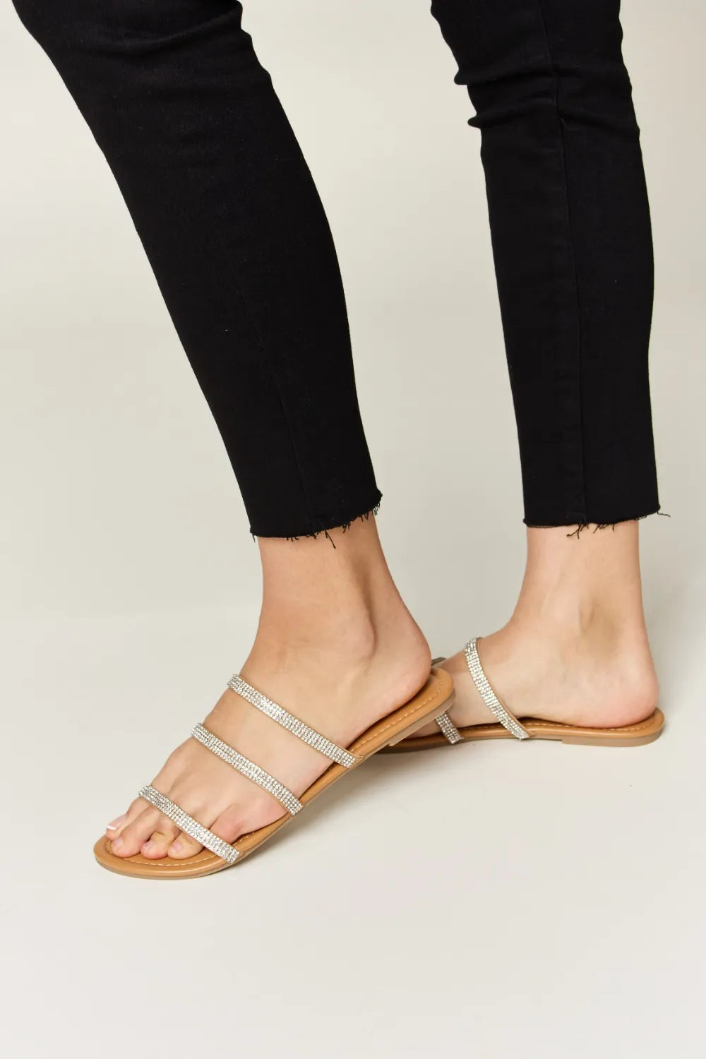 Tan WILD DIVA Rhinestone Three-Strap Flat Sandals by Trendsi, featuring sparkling rhinestones and comfortable flat design.