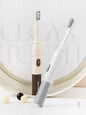 Trendsi rechargeable electric toothbrush with tan handle and one-size design, showing the brush head and sleek modern look.