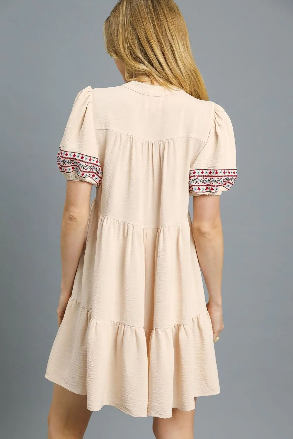Tan Umgee floral trim puff sleeve mini dress with ruffled details and a fitted silhouette, perfect for casual or semi-formal wear.