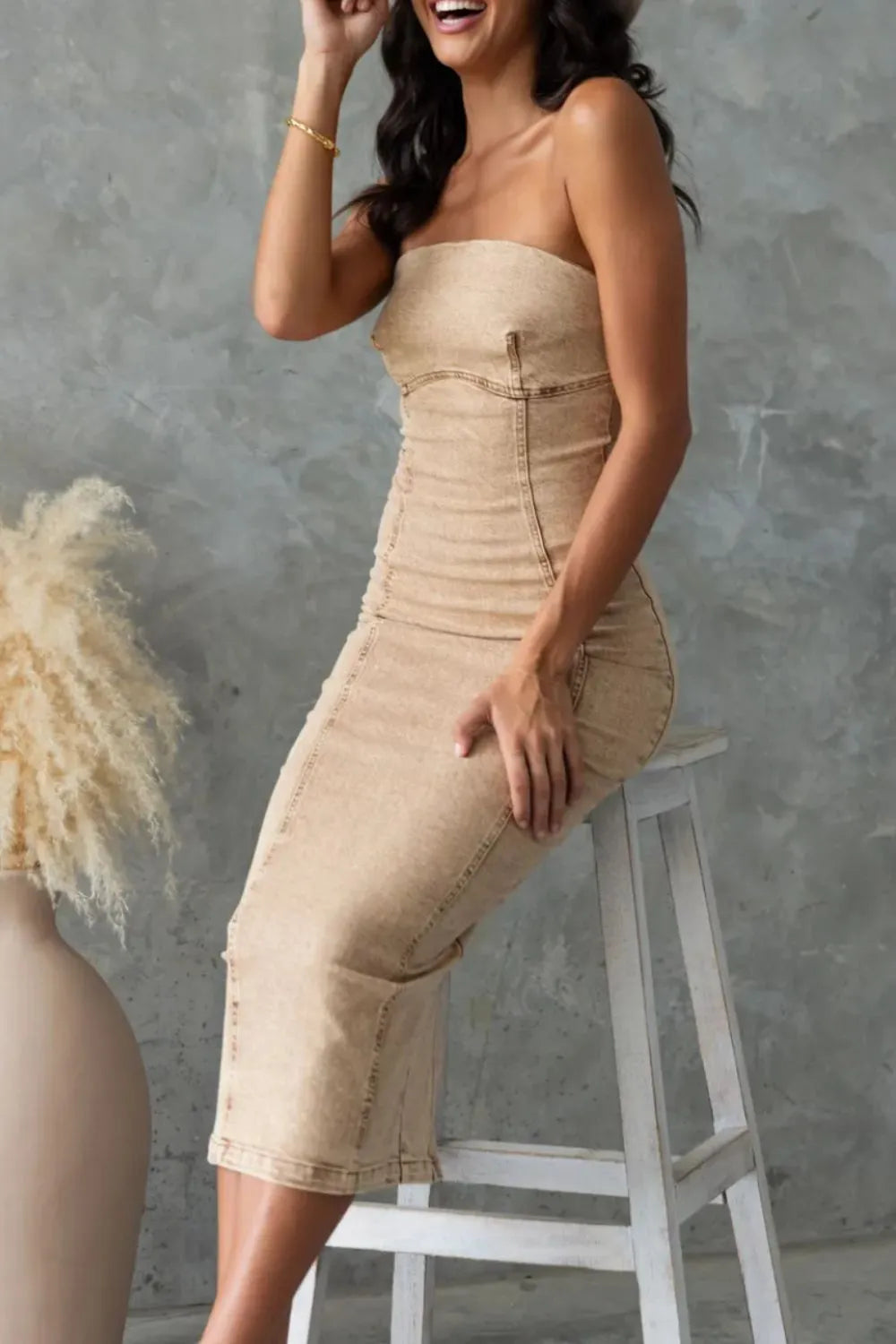 Washed tan slit-back tube denim dress by Trendsi featuring a fitted silhouette and stylish back slit detail.