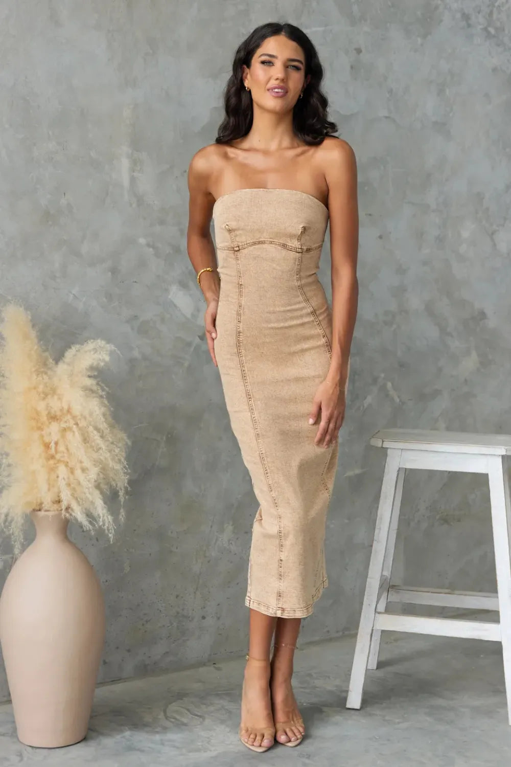 Tan washed slit-back tube denim dress by Trendsi, featuring a fitted silhouette and stylish back slit detail.