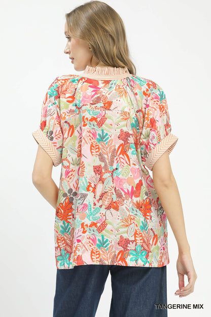 Umgee Mix Boho printed v-neck top with orange and white pattern, casual fit, lightweight fabric, and bohemian style.