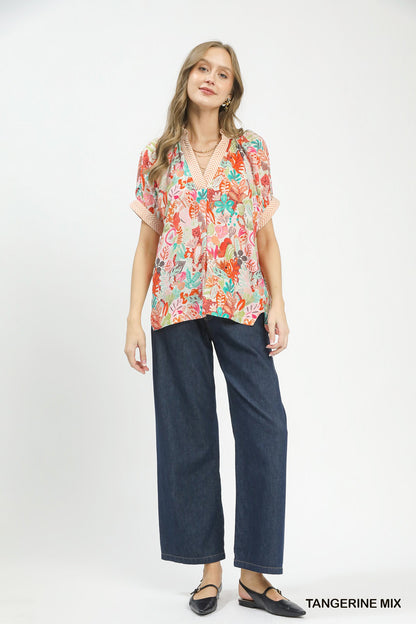 Umgee Mix Boho Printed V-Neck Top in vibrant tangerine and pattern, featuring a relaxed fit and stylish design.