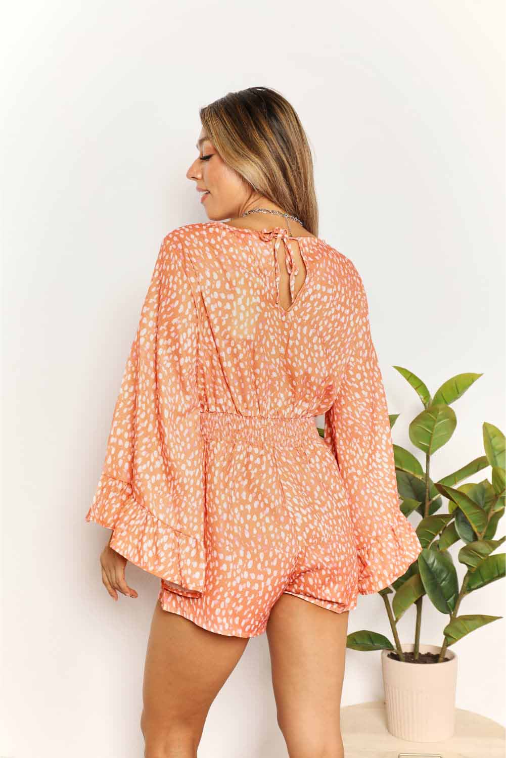 Tangerine double take printed flare sleeve surplice romper by Trendsi, featuring a V-neck and relaxed fit.