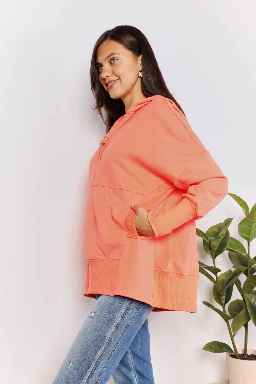 Tangerine Trendsi Double Take Quarter-Snap Dropped Shoulder Hoodie on a model, showcasing relaxed fit and casual style.