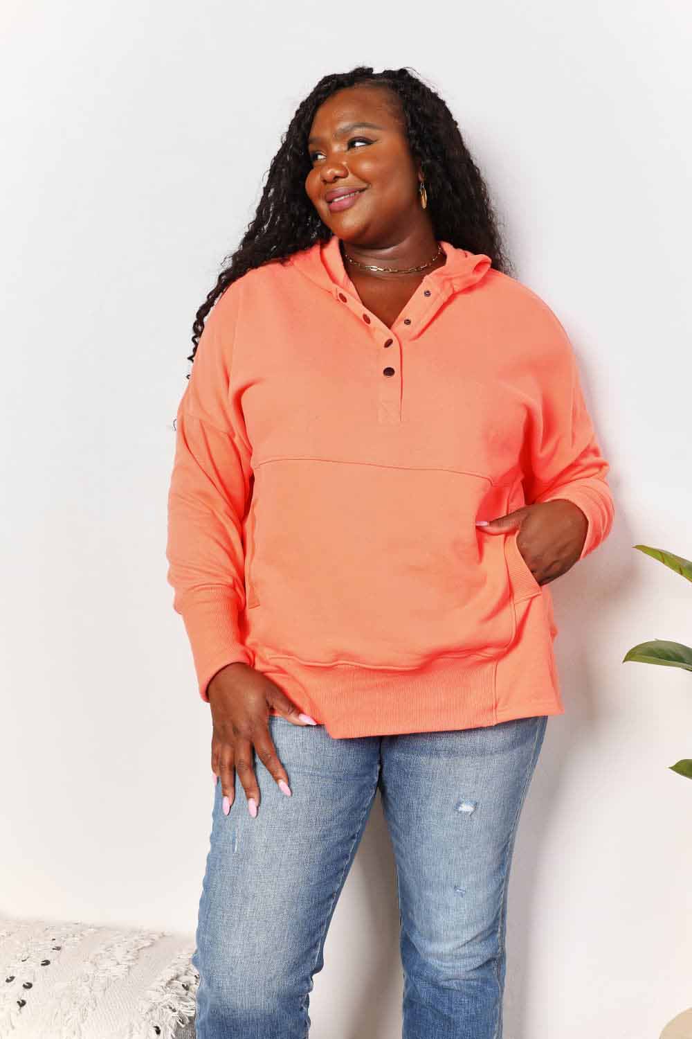 Tangerine double take quarter-snap dropped shoulder hoodie by Trendsi, featuring a relaxed fit and casual style.